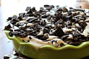a pie dish filled with ice cream and chopped Oreos 