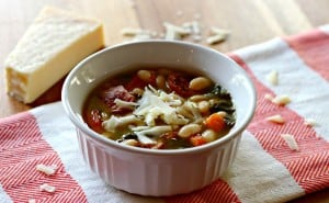 A bowl of soup with beans and sausage