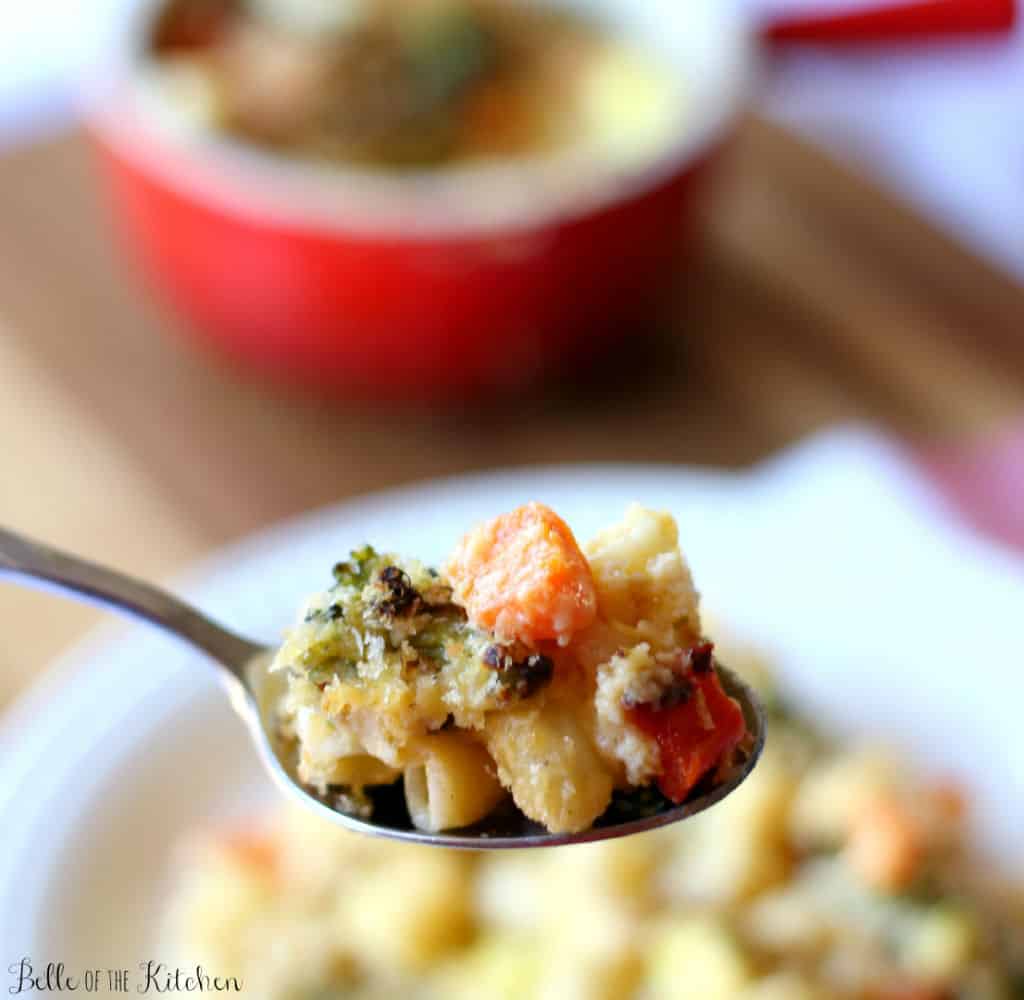 a spoon of macaroni and cheese with veggies
