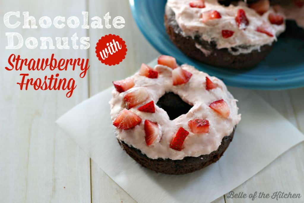 A close up of a donut with strawberries on top