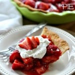 A slice of strawberry pie on a white plate with a fork