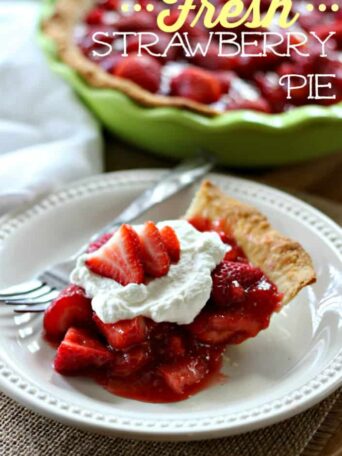A slice of strawberry pie on a white plate with a fork