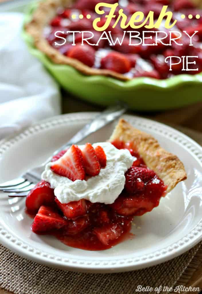 A slice of strawberry pie on a white plate with a fork