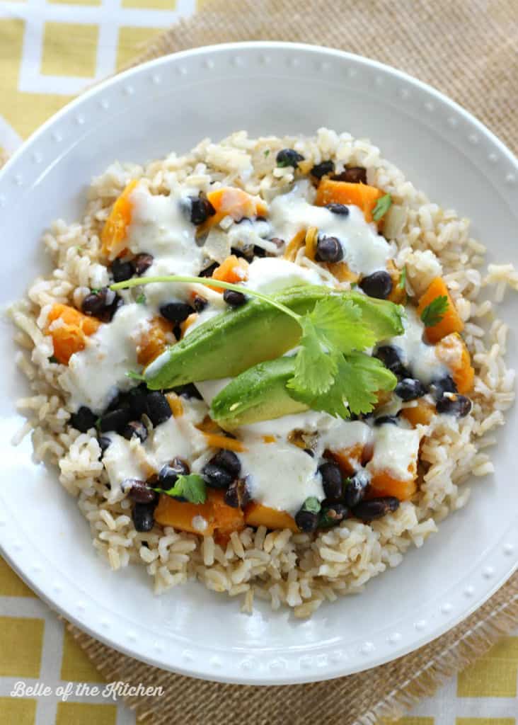 a bowl of rice with veggies and avocado