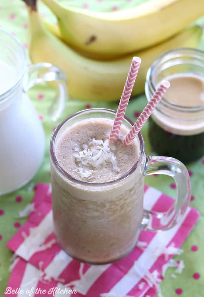 A smoothie in a jar with two straws