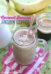 a smoothie in a glass with two pink straws and bananas in the background