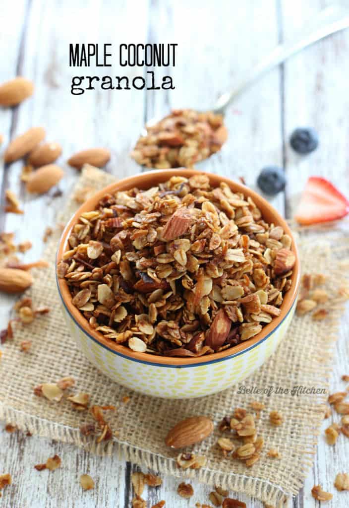 A close up of a bowl of granola with fruit in the background