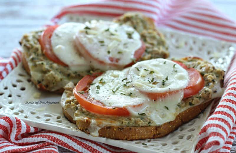 A close up of tuna pesto melts with sliced tomato