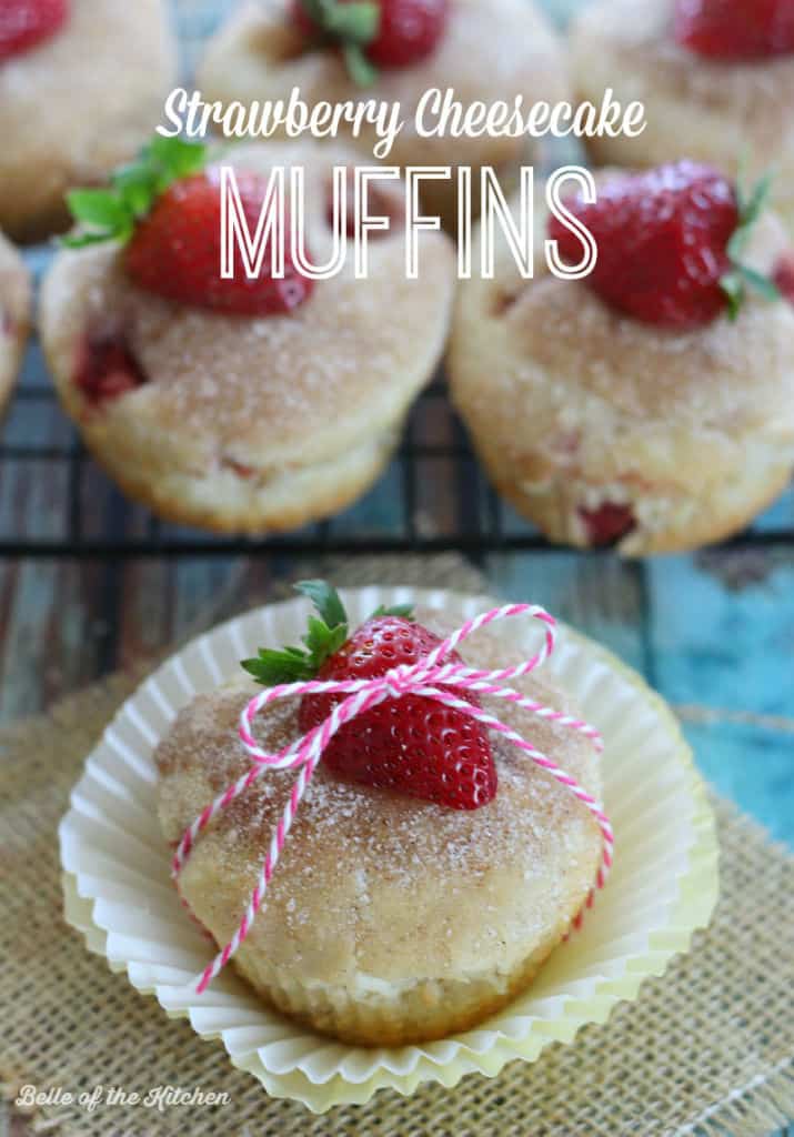 a muffin with strawberries beside it, wrapped in string