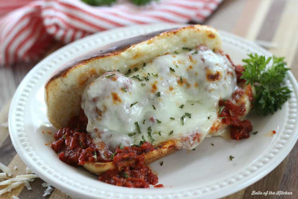 A plate with a meatball sandwich on it