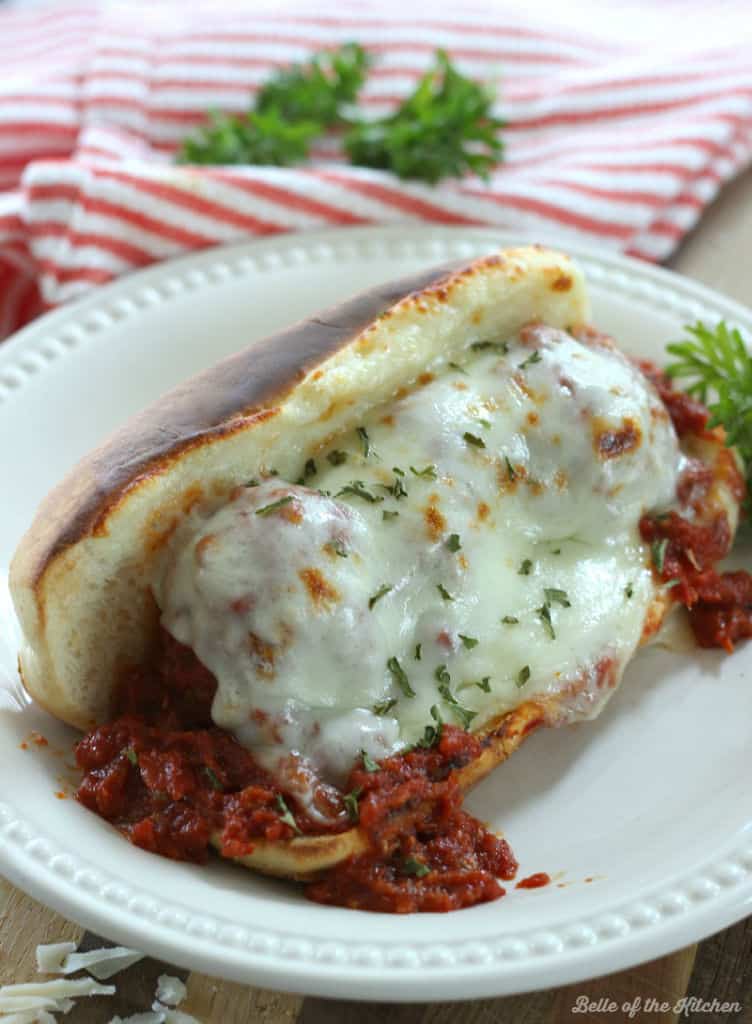 A plate with a meatball sandwich on it