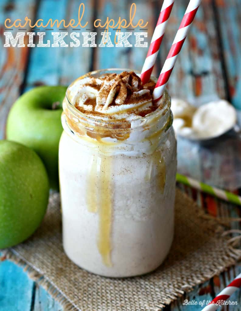 a milkshake beside green apples