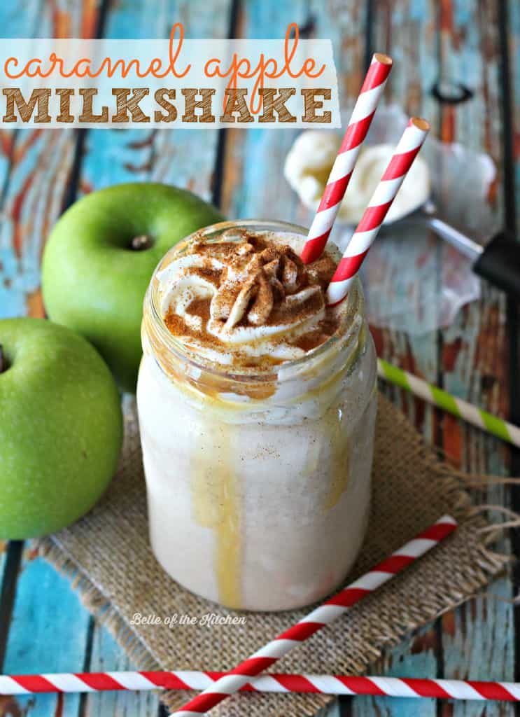 a milkshake beside green apples