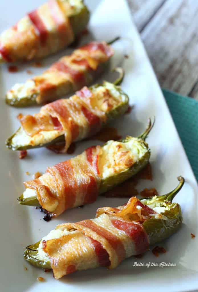 a plate filled with bacon wrapped peppers