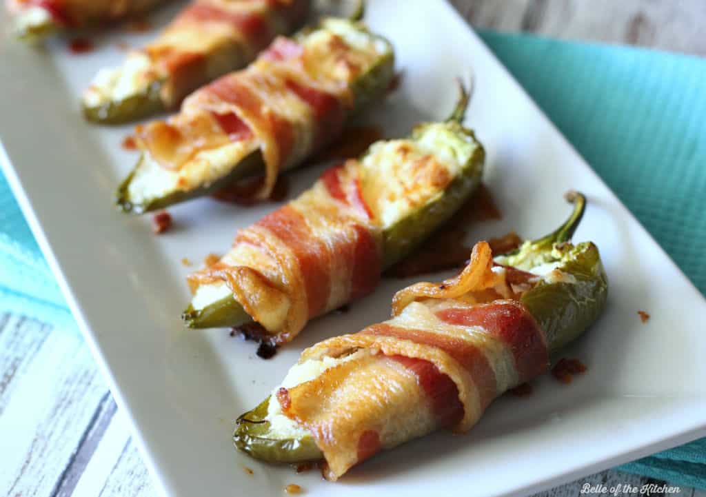 a plate filled with bacon wrapped peppers