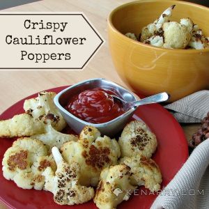 A plate of cauliflower poppers next to a small dish of ketchup