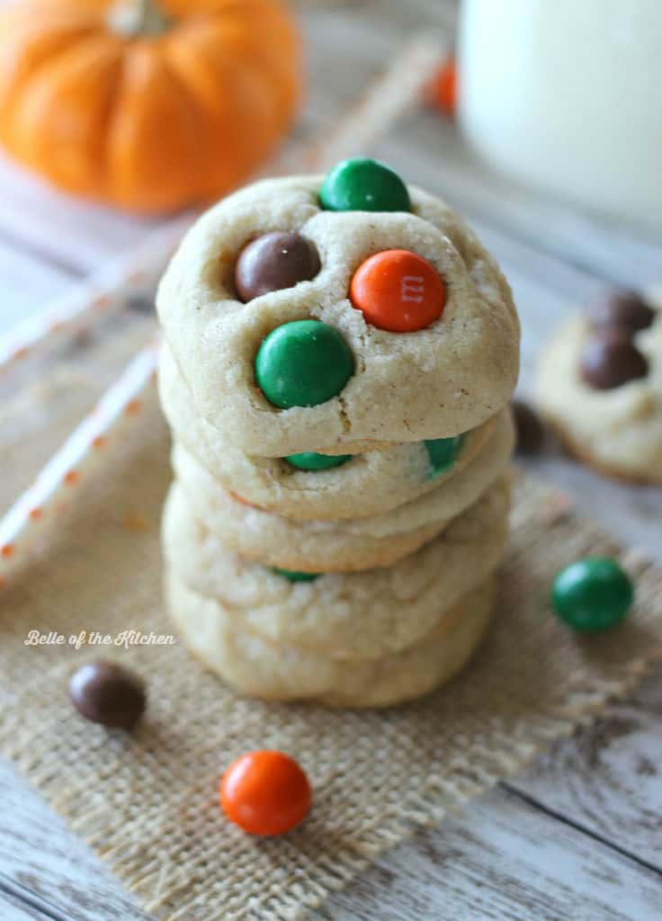 A close up of a stack of sugar cookies with M&Ms 