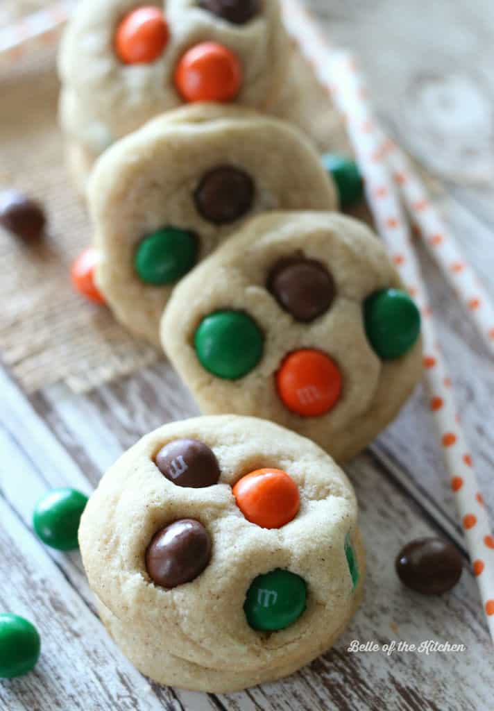 A close up of a stack of sugar cookies with M&Ms 
