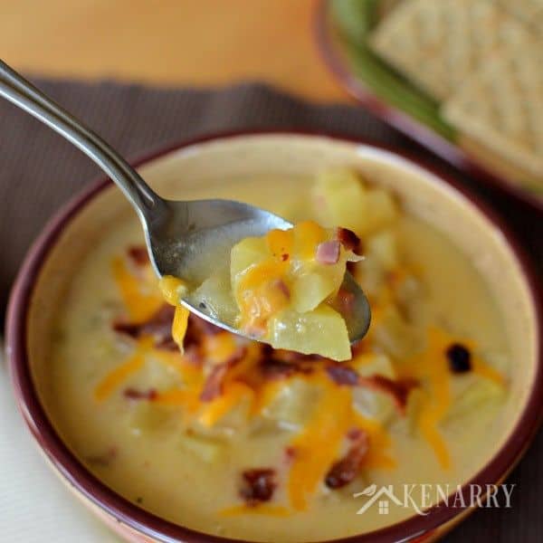 A bowl of potato soup topped with cheese and bacon