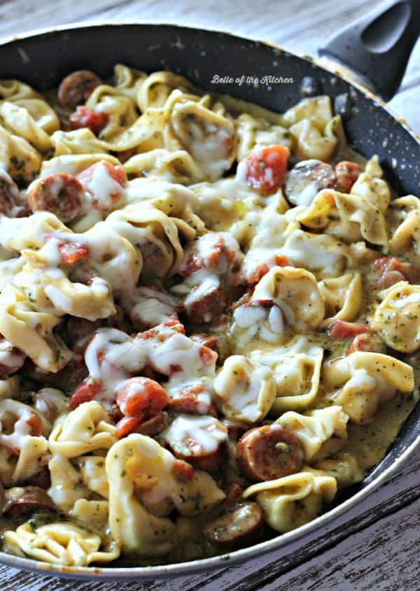 A pan filled with sausage and tortellini