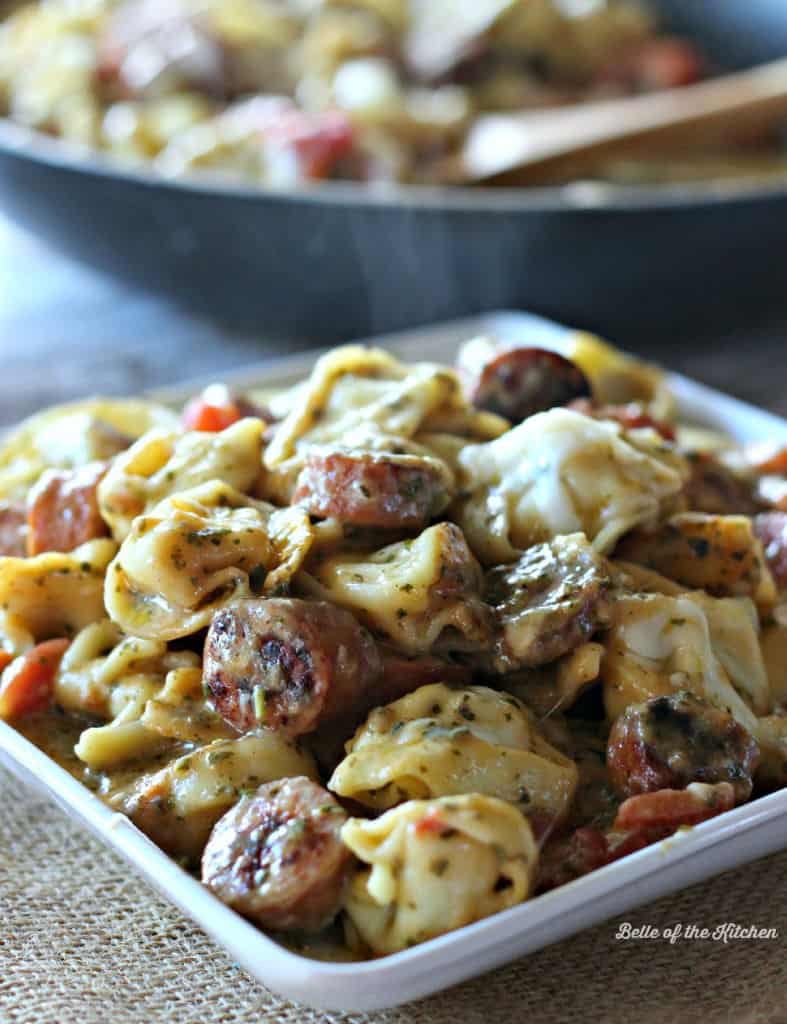 a plate of tortellini with sausage