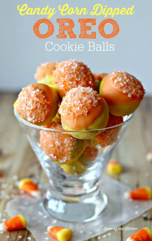 A close up of a glass full of yellow and orange cake balls