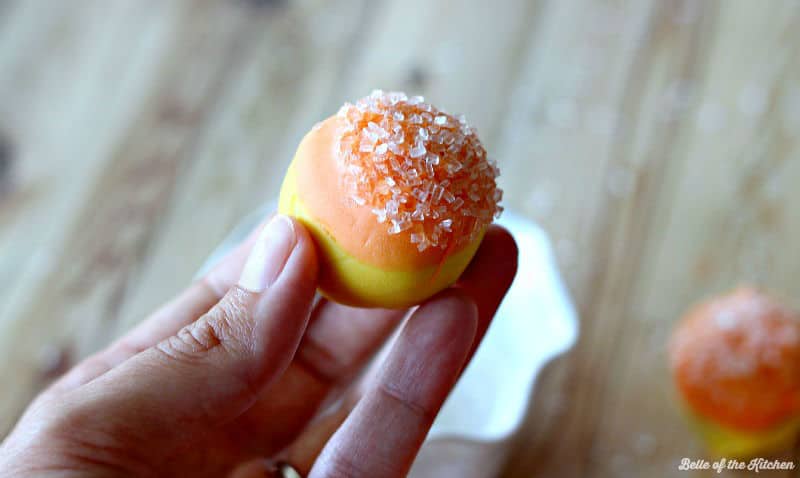 A close up of an orange and yellow cake ball