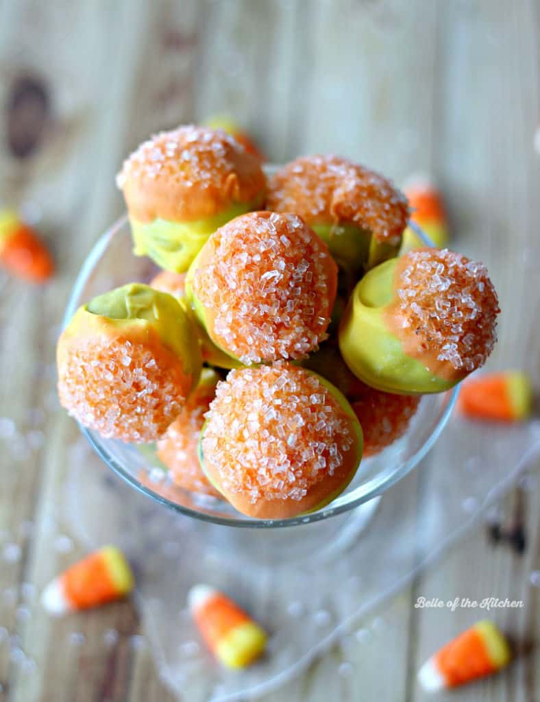 a glass full of orange and yellow cake balls