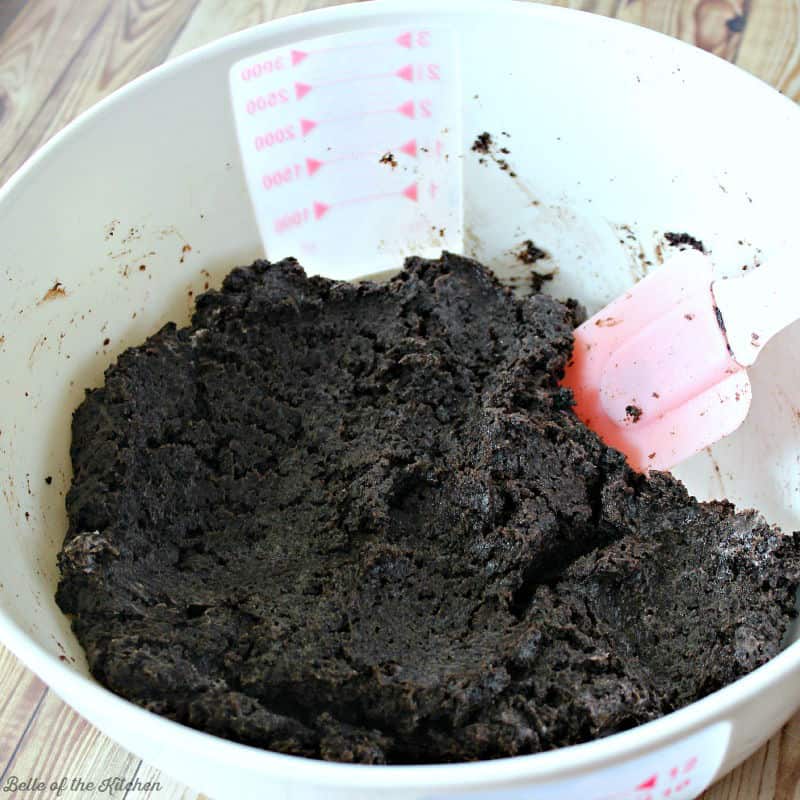 A close up of bowl of crushed Oreos and cream cheese