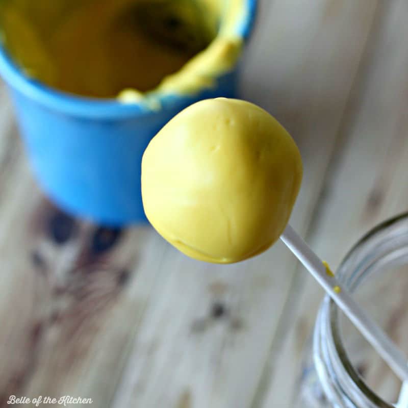 A close up of a yellow cake pop