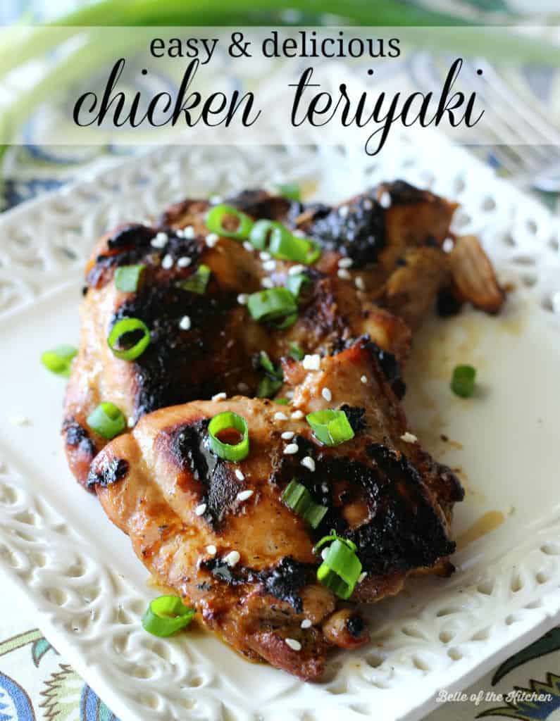 A close up of grilled chicken on a plate topped with green onions