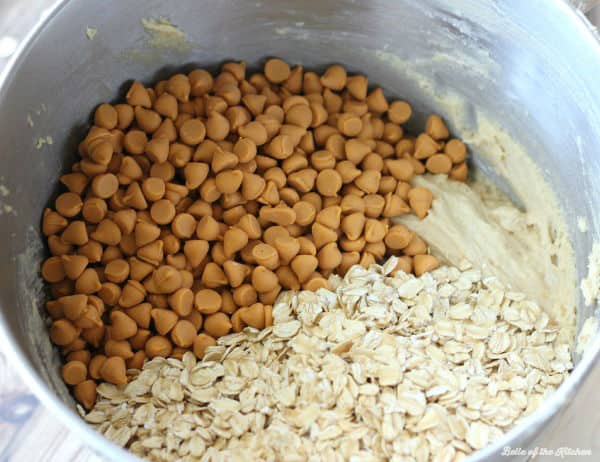 A bowl of cookie batter with oats and butterscotch chips