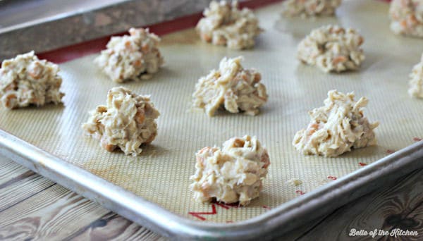 balls of raw cookie dough on a sheet pan