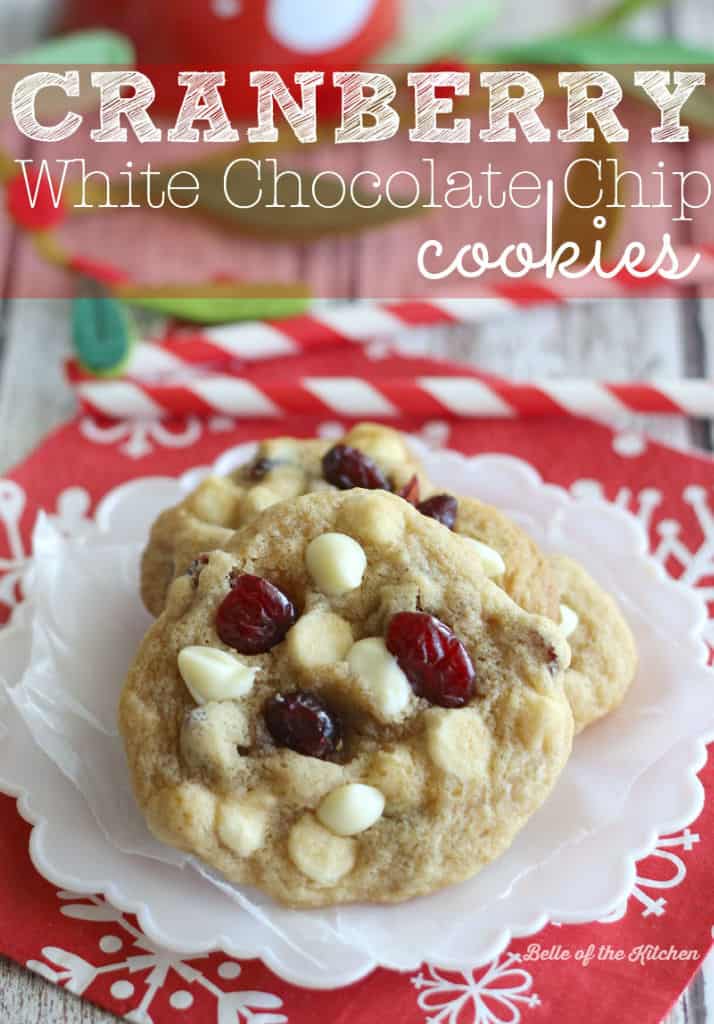 a plate of cookies with white chocolate chips and cranberries