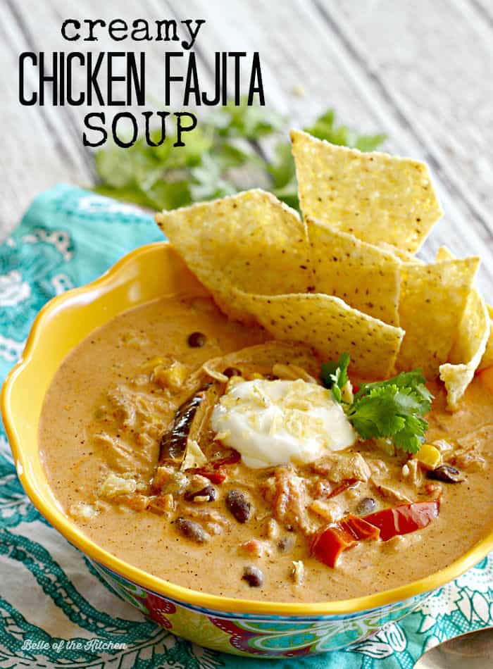 A bowl of soup with chicken, sour cream, and tortilla chips