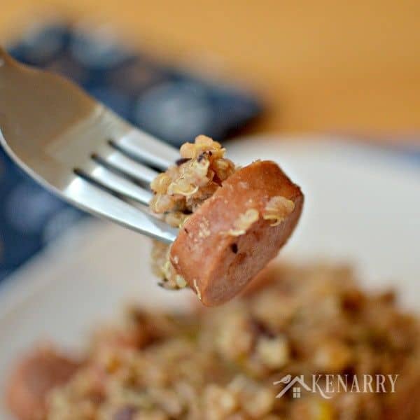 a fork filled with sausage and quinoa
