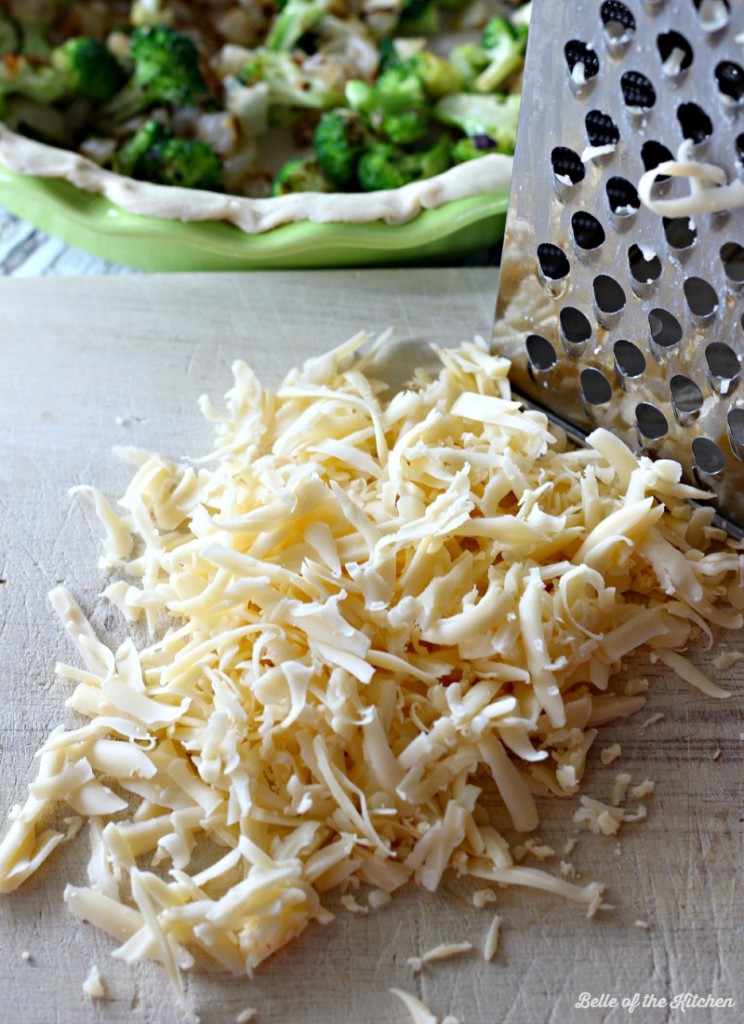 A close up of shredded cheese on a cutting board