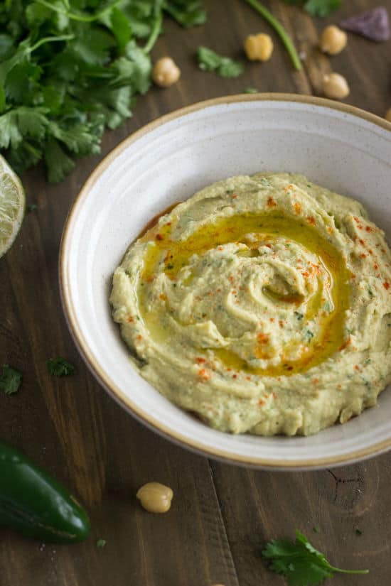 A bowl of food on a plate, with Hummus 