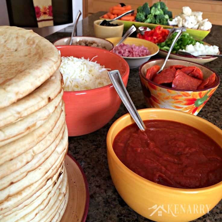 ingredients spread out on a counter to make pizzas