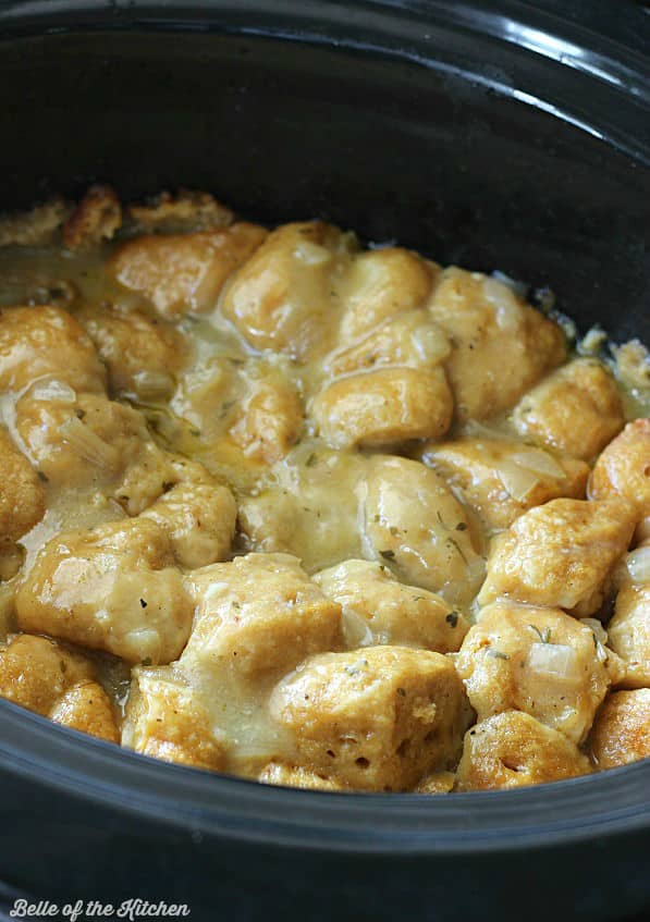 A crockpot of chicken and dumplings with gravy