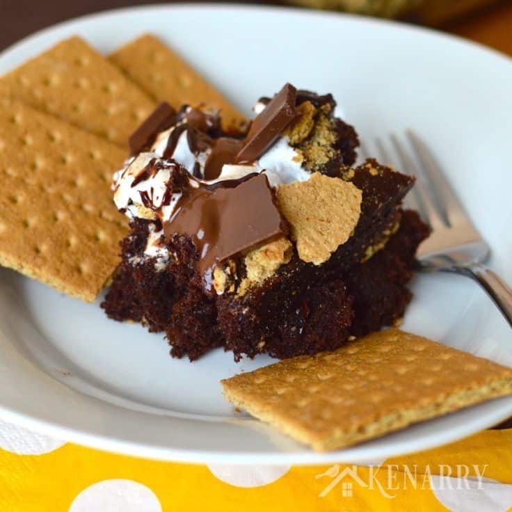 A piece of cake on a plate, with Chocolate and Fudge