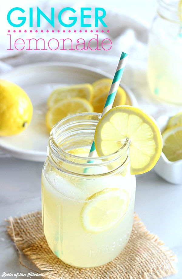 a glass of lemonade with a straw and lemon slice on the side