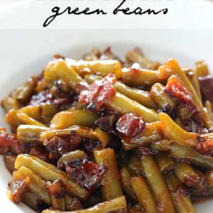 A plate of green beans with bacon and bbq sauce
