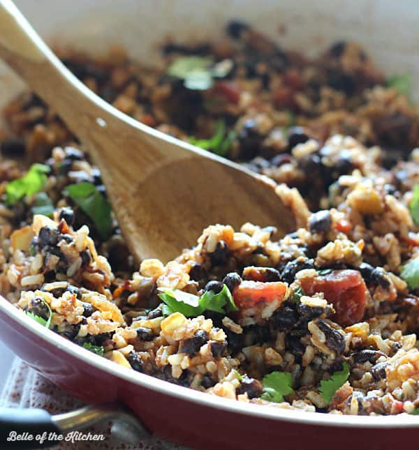 A skillet filled with rice, black beans, and cilantro