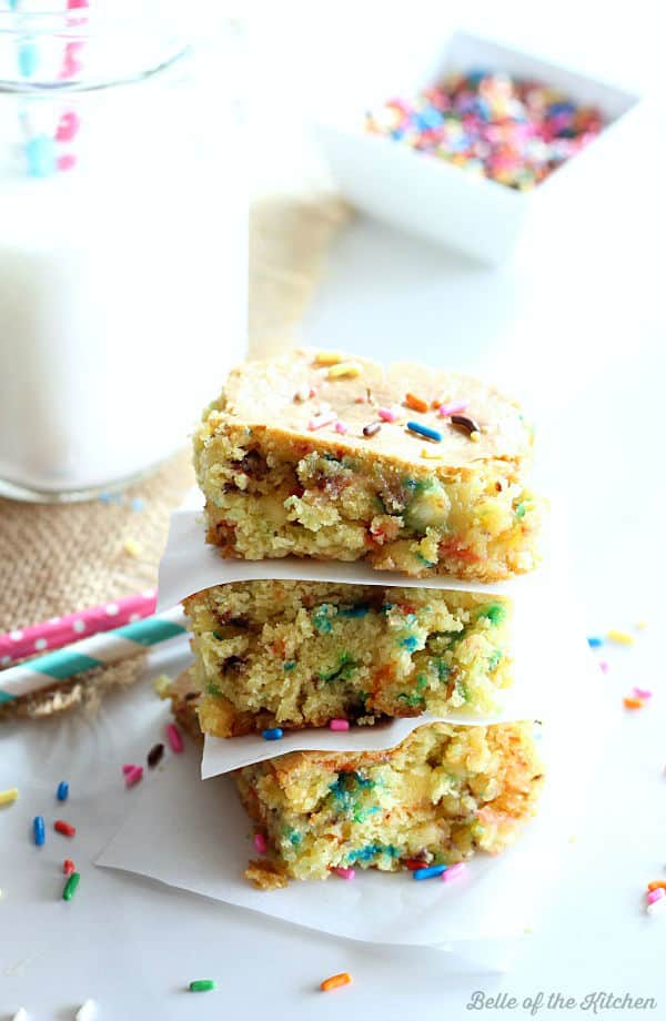a stack of cake batter bars topped with colorful sprinkles