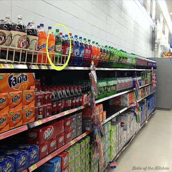 A store shelf of bottled soda