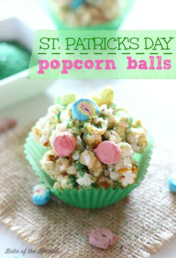 popcorn balls in green paper muffin cups topped with lucky charms marshmallows