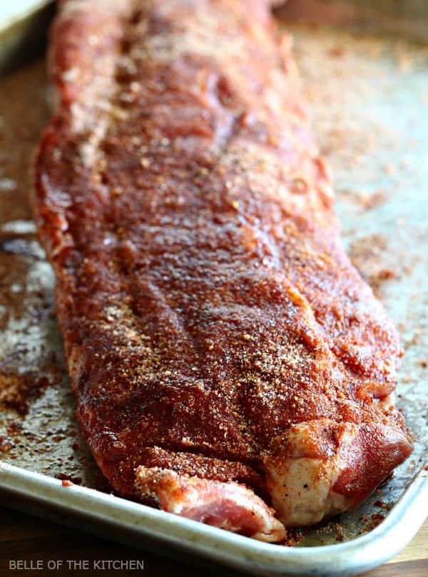 a rack of ribs sprinkled with seasoning