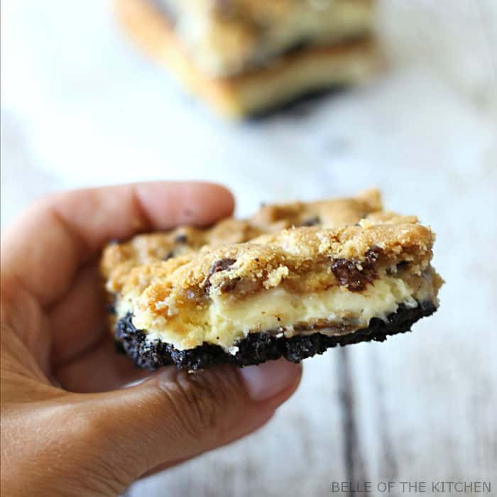 A hand holding an Oreo cheesecake bar