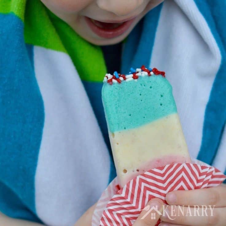 a child about to bite into a red, white, and blue pudding popsicle